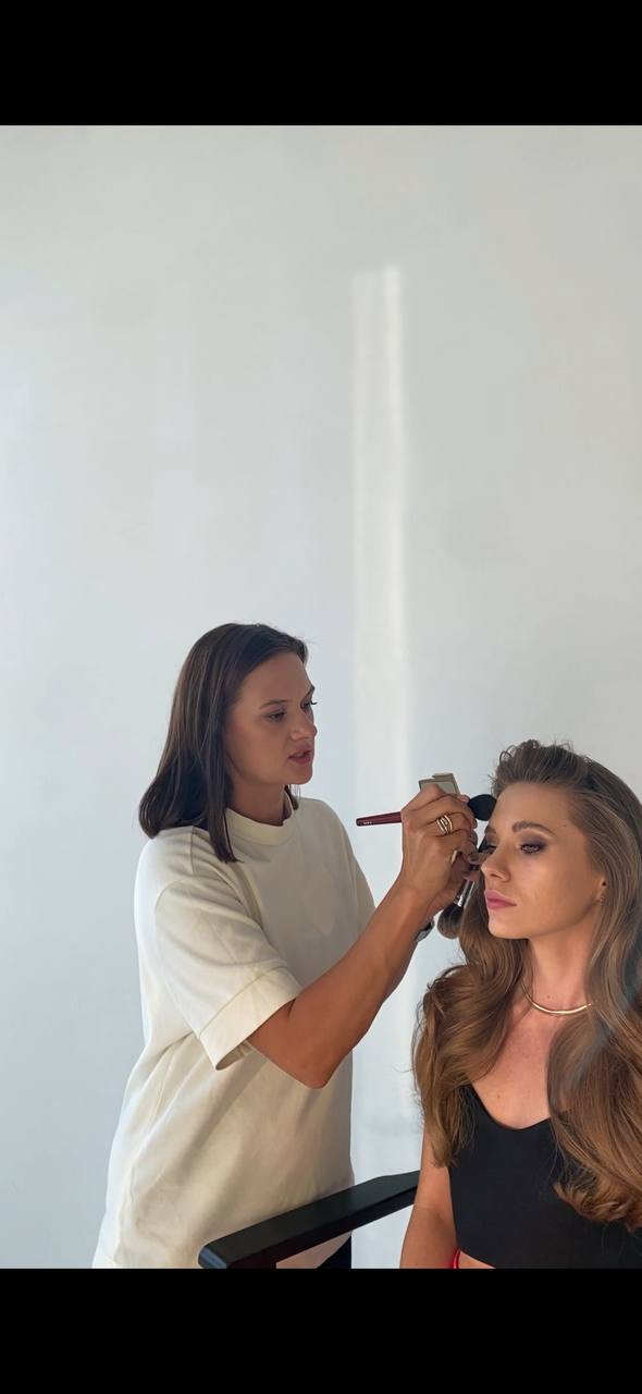 Makeup artist preparing a client